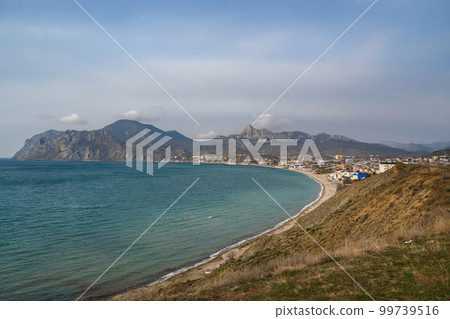 View of seaside resort city Koktebel , mountain Kara Dag from hill in spring. Crimea 99739516