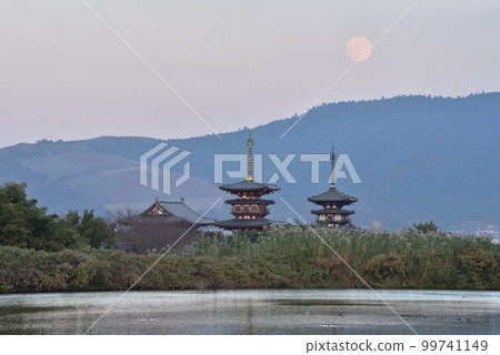 Twilight moonrise and scenery of Yakushiji Temple 99741149