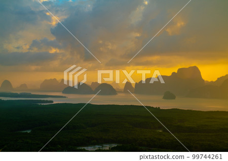 Morning sunrise colorful sky with cloud above sea bay forest with island 99744261