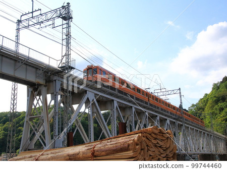 A train passing the Yoshino River Bridge on the Kintetsu Yoshino Line running in Nara Prefecture 99744460