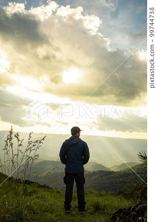 asian young man is standing on Mountain View asian young man is standing on Mountain View 99744738