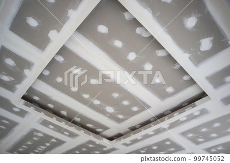 ceiling gypsum board installation at construction site 99745052