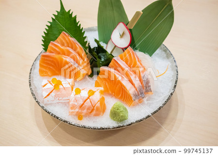 Fresh salmon slice sashimi serve on ice with wasabi Japanese style 99745137