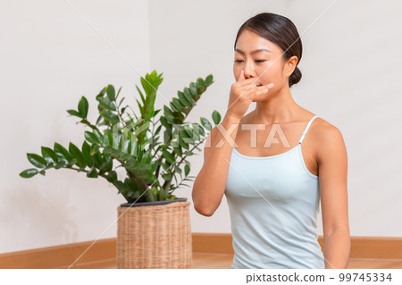 Asian woman doing breathing exercise before practice yoga.Healthy female inhaling and exhaling to deep breath exercise for control and balance life with yoga meditation decrease stress, relax her mind Asian woman doing breathing exercise before practice yoga.Healthy female inhaling and exhaling to deep breath exercise for control and balance life with yoga meditation decrease stress, relax her mind 99745334