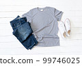 Grey T Shirt mockup weathered, canvas shoes and Jeans on white wood background 99746025