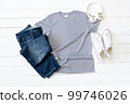 Grey T Shirt mockup weathered, canvas shoes, earphones and Jeans on white wood background 99746026