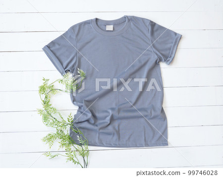 Grey T Shirt mockup on white wood background Grey T Shirt mockup on white wood background 99746028