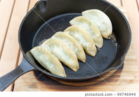 Handmade dumplings baked in a skillet 99746949