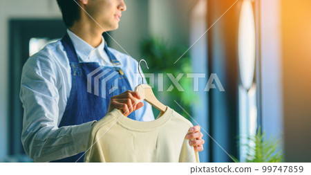 Male clerk with clothing Male clerk with clothing 99747859