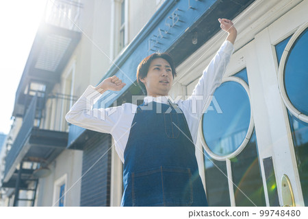 Stretching male shop staff Stretching male shop staff 99748480