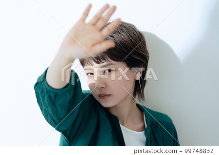 Portrait of a young woman worried about UV rays Portrait of a young woman worried about UV rays 99748832