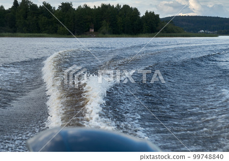 Trail from a speedboat on the water Trail from a speedboat on the water 99748840