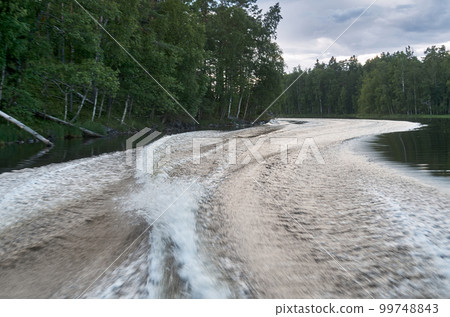 Trail from a speedboat on the water Trail from a speedboat on the water 99748843