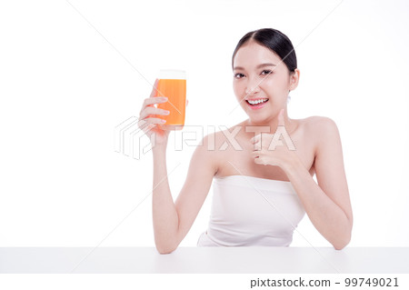 Portrait of Beautiful young woman holding orange juicy and smile isolated on white background. Portrait of Beautiful young woman holding orange juicy and smile isolated on white background. 99749021