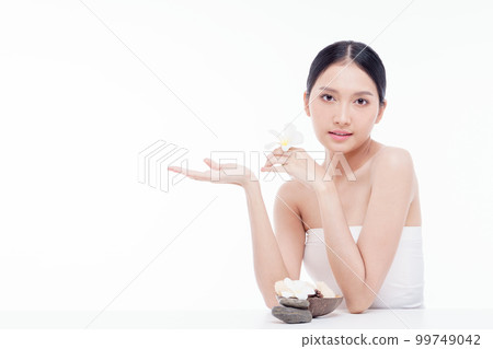 Beauty woman perfect face fresh clean skin portrait isolated on white. Beautiful asian girl holding plumeria flowers with make up and beauty healthy skin color lips red and hair portrait. Spa and skin Beauty woman perfect face fresh clean skin portrait isolated on white. Beautiful asian girl holding plumeria flowers with make up and beauty healthy skin color lips red and hair portrait. Spa and skin 99749042