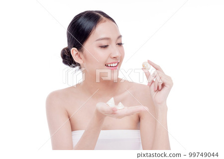 Woman holding Shells polished to pearly surface. The polished shells before being used to make pearl jewelry 99749044