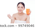 Portrait of Beautiful young woman holding orange juicy and smile isolated on white background. 99749046