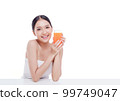 Portrait of Beautiful young woman holding orange juicy and smile isolated on white background. 99749047