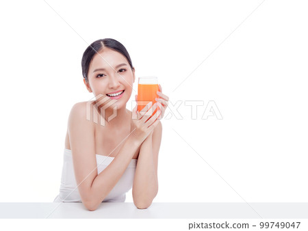 Portrait of Beautiful young woman holding orange juicy and smile isolated on white background. Portrait of Beautiful young woman holding orange juicy and smile isolated on white background. 99749047