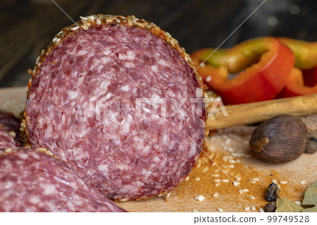 Sliced sausage with spices and lots of sesame seeds Sliced sausage with spices and lots of sesame seeds 99749528
