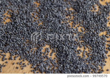 Poppy seeds on the table close up Poppy seeds on the table close up 99749570