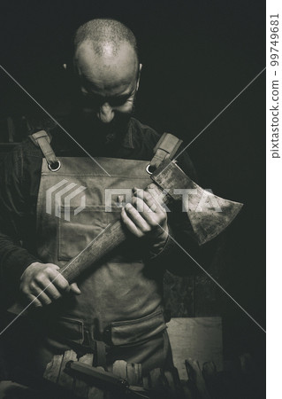 man with axe in hand and leather apron man with axe in hand and leather apron 99749681