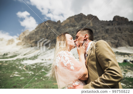 Loving husband and woman on the background of the mountains. Loving couple emotionally spends time 99750822