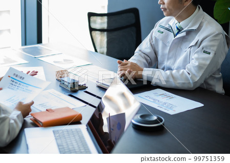 Engineer discussing construction plans faceless Engineer discussing construction plans faceless 99751359