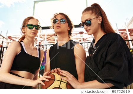 Group of smiling friends in sunglasses sitting with food in city square concept of friendship, vacation, summer and people. Group of smiling friends in sunglasses sitting with food in city square concept of friendship, vacation, summer and people. 99752619