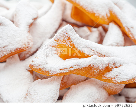 Close-up of white powdered sugar that looks like snow on homemade cookies. Close-up of white powdered sugar that looks like snow on homemade cookies. 99752625