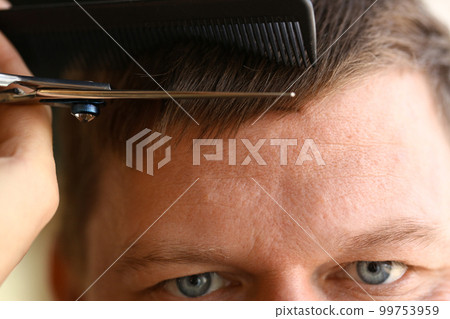 Skillful hands of hairdresser cut and comb man bangs 99753959