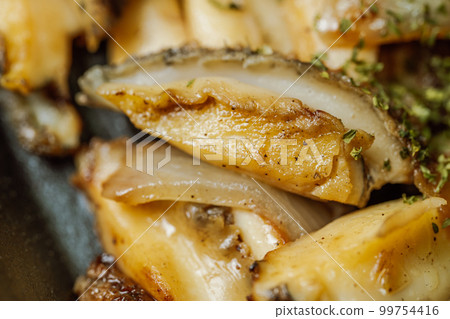 Korean food abalone butter grilled dish in black bowl Korean food abalone butter grilled dish in black bowl 99754416