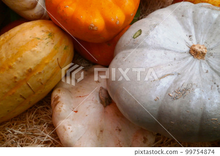 Stack of winter squashes on a market stall 99754874