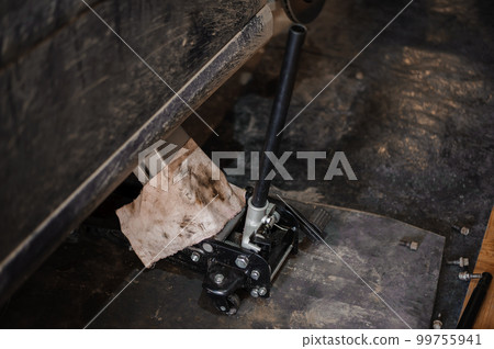 Car suspension repair. Hydraulic jack, car wheel replacement Car suspension repair. Hydraulic jack, car wheel replacement 99755941