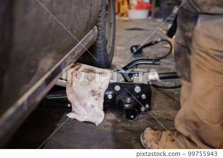 Car suspension repair. Hydraulic jack, car wheel replacement 99755943