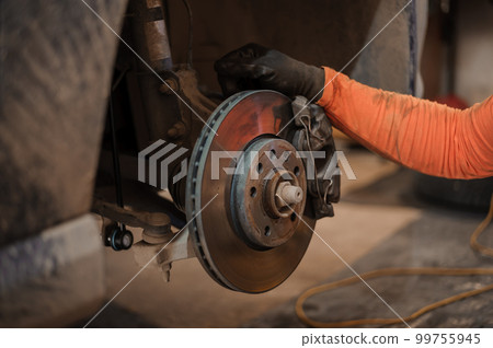 Car brake part in the garage, car brake disc without wheels. Car suspension. Current car repair 99755945