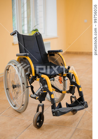 Children's wheelchair. Empty wheelchair in the hospital. Wheelchair close up 99756016