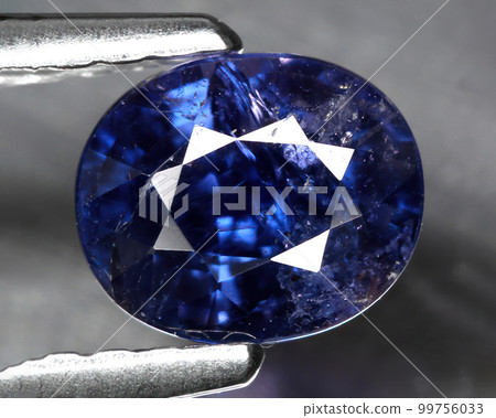 Natural gemstone blue sapphire on gray background 99756033