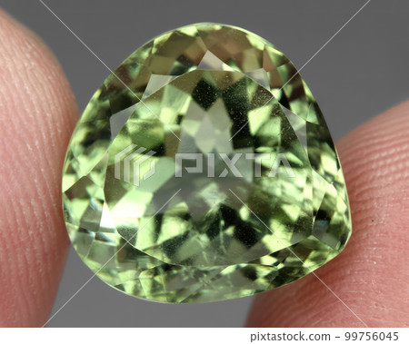 Natural gemstone green prasiolite amethyst on gray background Natural gemstone green prasiolite amethyst on gray background 99756045