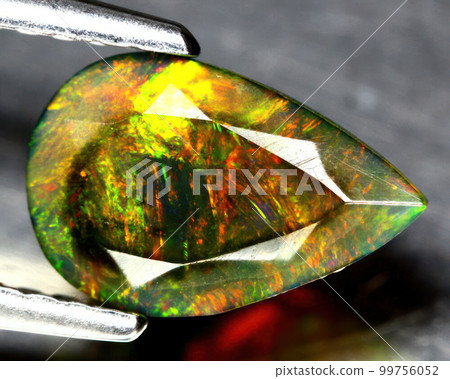 Natural precious stone noble opal on a black background 99756052