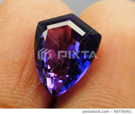Natural gemstone purple amethyst on gray background 99756061