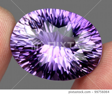 Natural gemstone purple amethyst on gray background Natural gemstone purple amethyst on gray background 99756064