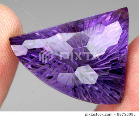 Natural gemstone purple amethyst on gray background 99756093