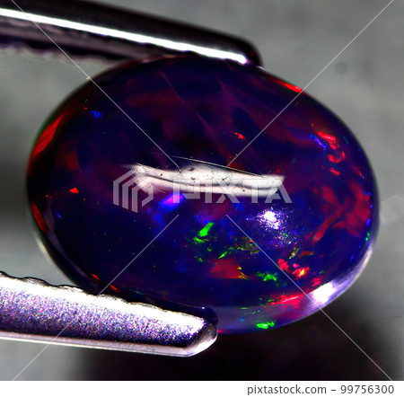 Natural gemstone rainbow opal on gray background 99756300