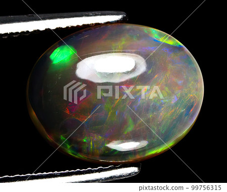 Natural gemstone rainbow opal on gray background Natural gemstone rainbow opal on gray background 99756315