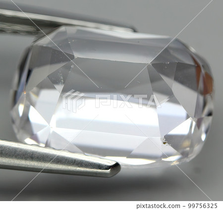Natural precious pink kunzite stone on gray background 99756325