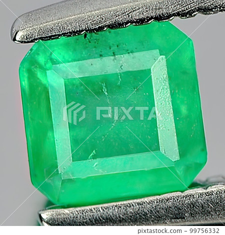 Natural gemstone green emerald on gray background Natural gemstone green emerald on gray background 99756332