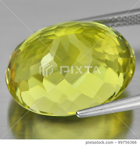 Natural gemstone yellow citrine on gray background 99756366