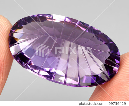 Natural gemstone purple amethyst on gray background Natural gemstone purple amethyst on gray background 99756429