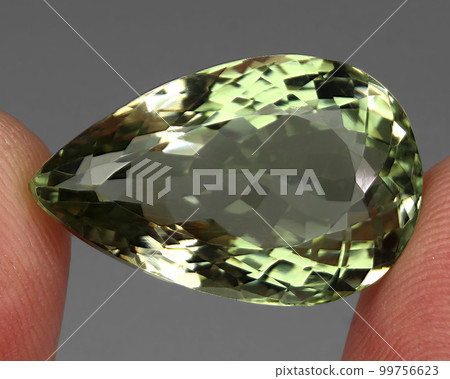 Natural precious green amethyst prasiolite on a gray background Natural precious green amethyst prasiolite on a gray background 99756623